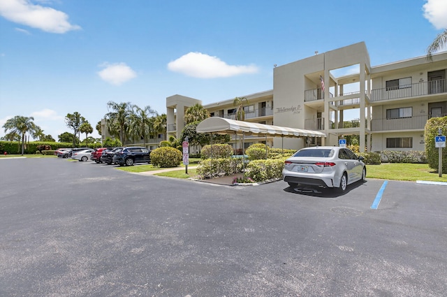 5574 Witney Dr Unit 104, Delray Beach, FL 33484 - view of property featuring uncovered parking