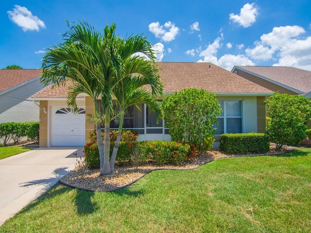 374 NW Sherry Ln, Port Saint Lucie, FL 34986 - view of property hidden behind natural elements with stucco siding, concrete driveway, roof with shingles, and a front lawn