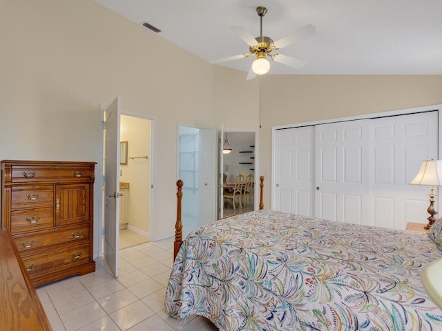 374 NW Sherry Ln, Port Saint Lucie, FL 34986 - bedroom with a closet, vaulted ceiling, light tile patterned floors, ceiling fan, and connected bathroom