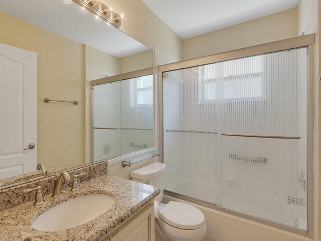 374 NW Sherry Ln, Port Saint Lucie, FL 34986 - bathroom with vanity, plenty of natural light, and shower / bath combination with glass door