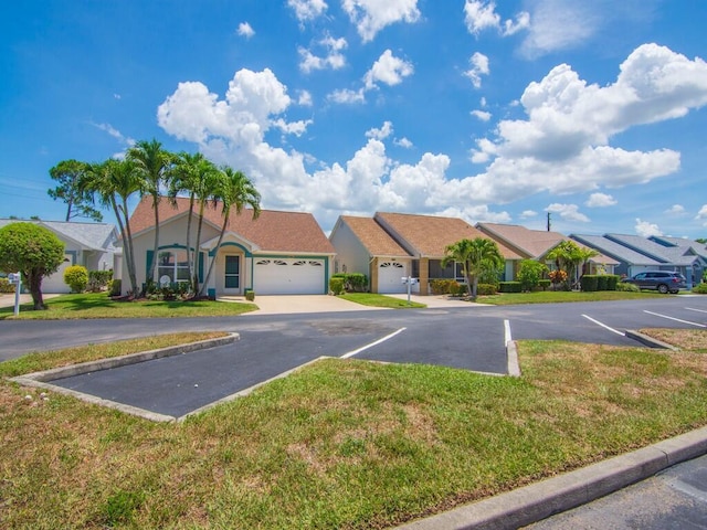 374 NW Sherry Ln, Port Saint Lucie, FL 34986 - view of front of property with a residential view, a front lawn, stucco siding, and uncovered parking