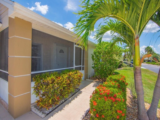 374 NW Sherry Ln, Port Saint Lucie, FL 34986 - doorway to property with a lawn