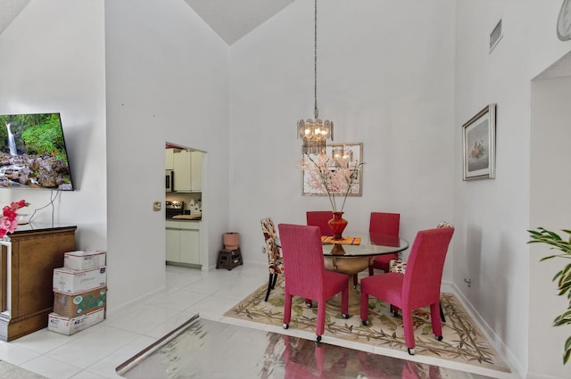 14085 Nesting Way Unit C, Delray Beach, FL 33484 - dining space with high vaulted ceiling, a chandelier, and light tile patterned flooring