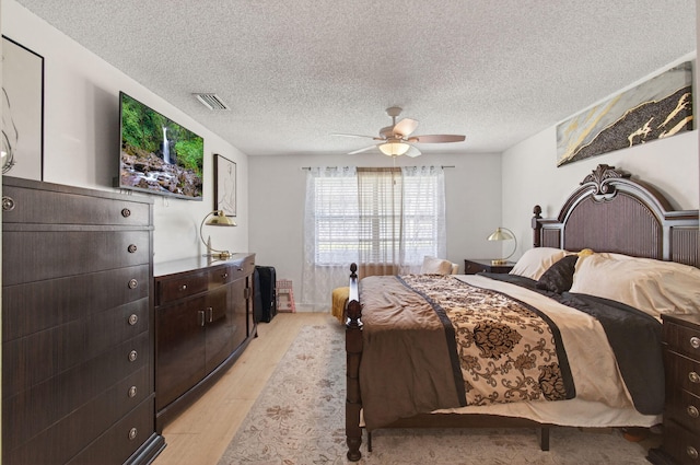 14085 Nesting Way Unit C, Delray Beach, FL 33484 - bedroom with light wood-style floors, a textured ceiling, and a ceiling fan