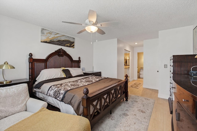14085 Nesting Way Unit C, Delray Beach, FL 33484 - bedroom with light wood-style floors, a textured ceiling, a ceiling fan, connected bathroom, and recessed lighting