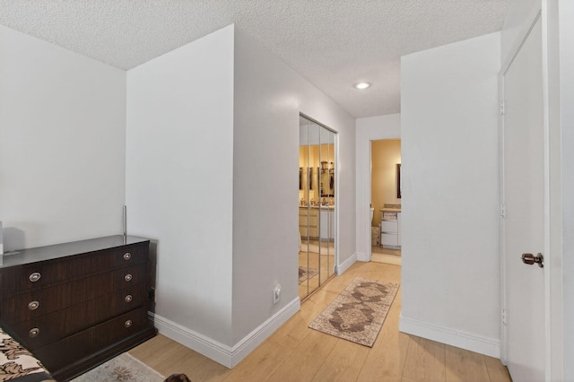 14085 Nesting Way Unit C, Delray Beach, FL 33484 - hall with light wood-style floors, a textured ceiling, and recessed lighting
