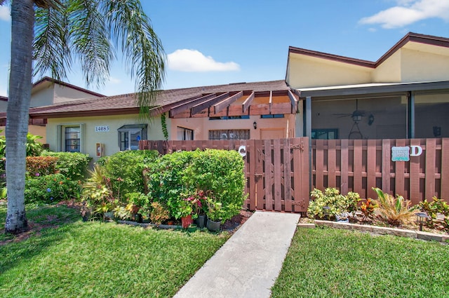 14085 Nesting Way Unit C, Delray Beach, FL 33484 - view of property exterior featuring stucco siding, a gate, and ceiling fan