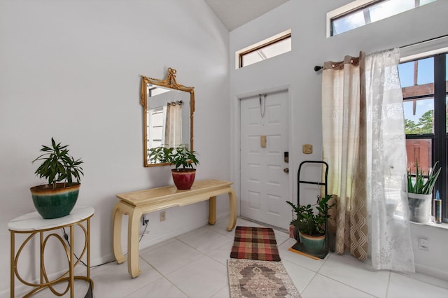 14085 Nesting Way Unit C, Delray Beach, FL 33484 - foyer featuring light tile patterned floors and a towering ceiling