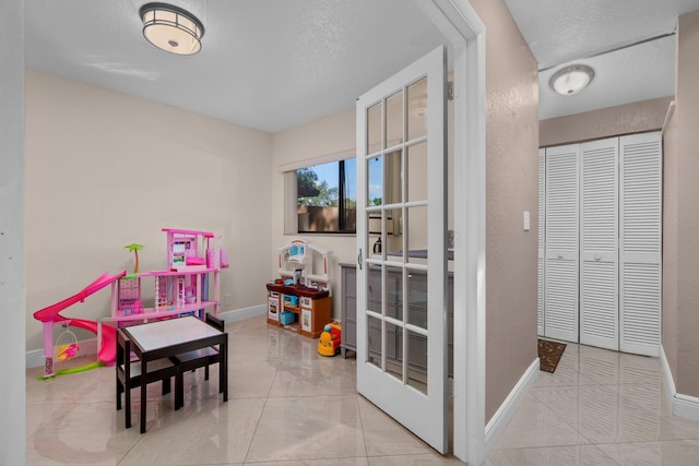 7670 NW 79th Ave Unit O3, Tamarac, FL 33321 - game room featuring a textured ceiling and baseboards