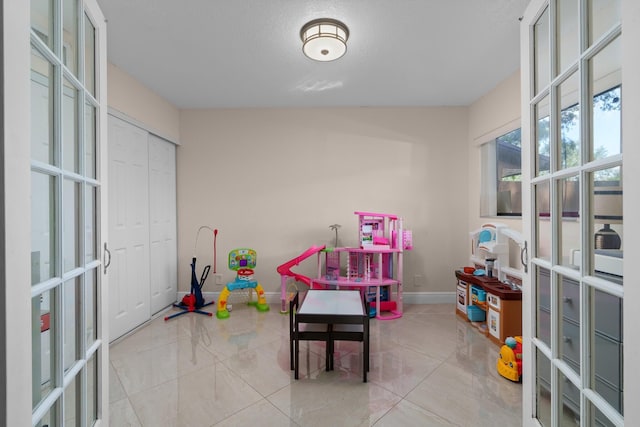 7670 NW 79th Ave Unit O3, Tamarac, FL 33321 - recreation room featuring french doors and baseboards