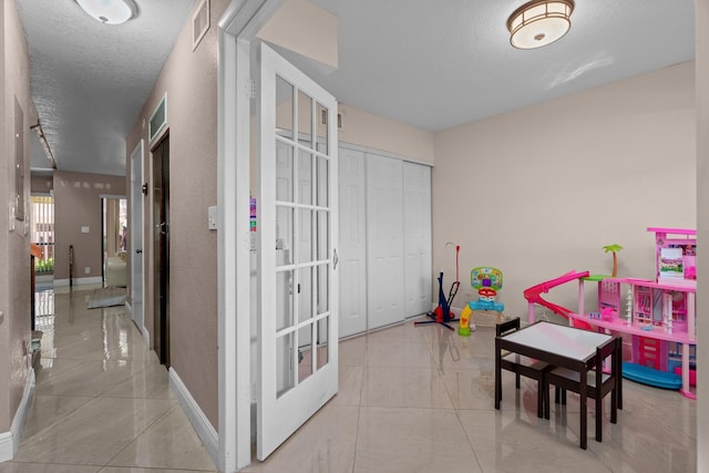 7670 NW 79th Ave Unit O3, Tamarac, FL 33321 - game room with a textured ceiling and french doors