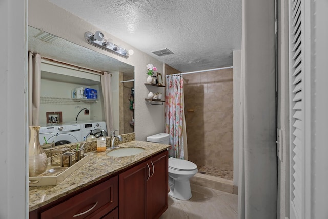 7670 NW 79th Ave Unit O3, Tamarac, FL 33321 - bathroom with vanity, tiled shower, a textured ceiling, separate washer and dryer, and tile patterned flooring