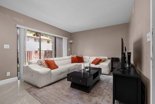 7670 NW 79th Ave Unit O3, Tamarac, FL 33321 - living room featuring a textured ceiling