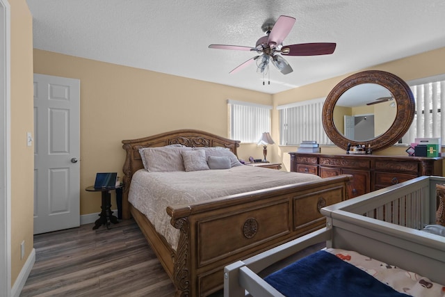 7670 NW 79th Ave Unit O3, Tamarac, FL 33321 - bedroom featuring dark wood-style flooring, a textured ceiling, and a ceiling fan