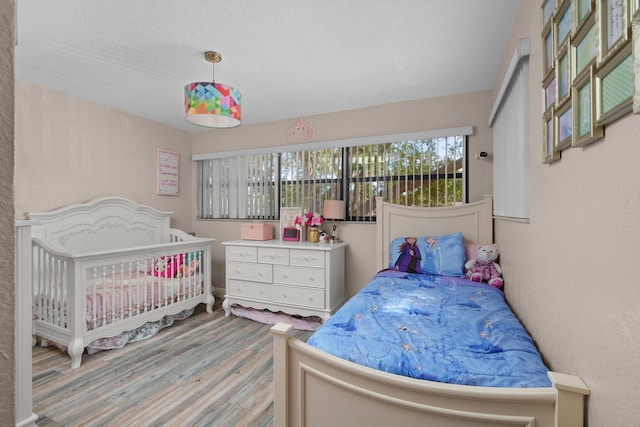 7670 NW 79th Ave Unit O3, Tamarac, FL 33321 - bedroom featuring multiple windows and wood finished floors