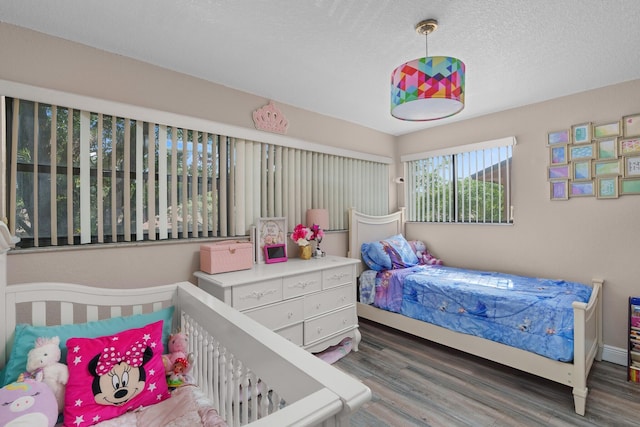 7670 NW 79th Ave Unit O3, Tamarac, FL 33321 - bedroom featuring wood finished floors and a textured ceiling