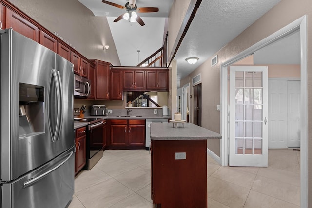 7670 NW 79th Ave Unit O3, Tamarac, FL 33321 - kitchen with appliances with stainless steel finishes, ceiling fan, dark brown cabinets, and light tile patterned flooring