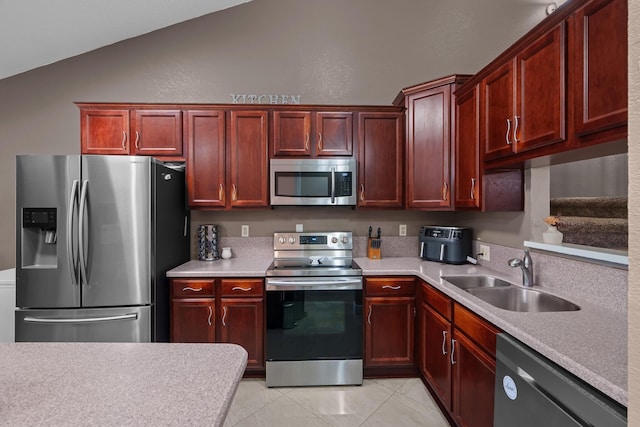 7670 NW 79th Ave Unit O3, Tamarac, FL 33321 - kitchen with stainless steel appliances, dark brown cabinets, vaulted ceiling, light countertops, and light tile patterned floors