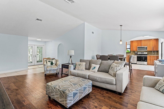 7800 Texas Trl, Boca Raton, FL 33487 - living room featuring arched walkways, light wood finished floors, and french doors