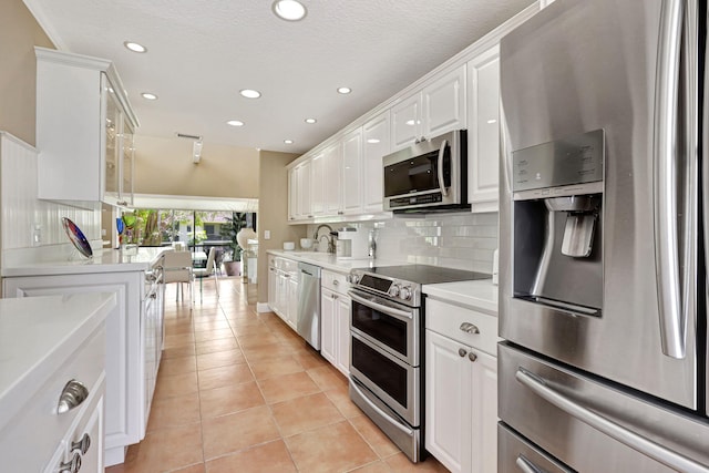 6890 Willow Wood Dr Unit 206, Boca Raton, FL 33434 - kitchen featuring appliances with stainless steel finishes, recessed lighting, backsplash, white cabinetry, and light tile patterned floors