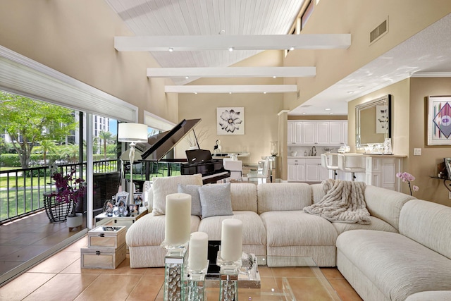 6890 Willow Wood Dr Unit 206, Boca Raton, FL 33434 - living area featuring light tile patterned floors, high vaulted ceiling, and beamed ceiling