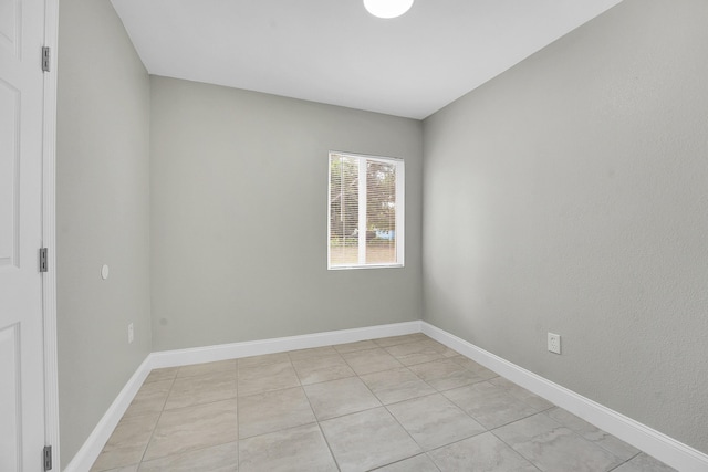 306 N N 28th St, Fort Pierce, FL 34947 - spare room with baseboards and light tile patterned floors