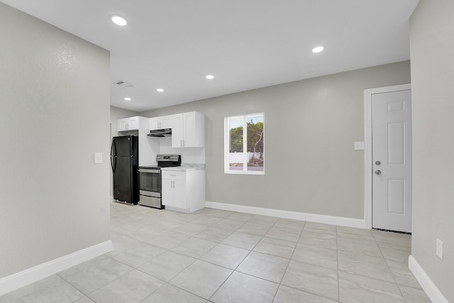 306 N N 28th St, Fort Pierce, FL 34947 - kitchen with electric range, freestanding refrigerator, under cabinet range hood, white cabinets, and recessed lighting