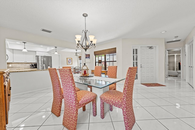 11265 Bannock Ave Unit 5, Boynton Beach, FL 33437 - dining room featuring a chandelier, a textured ceiling, light tile patterned floors, and recessed lighting