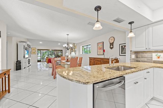 11265 Bannock Ave Unit 5, Boynton Beach, FL 33437 - kitchen with stainless steel dishwasher, a peninsula, plenty of natural light, white cabinetry, and recessed lighting