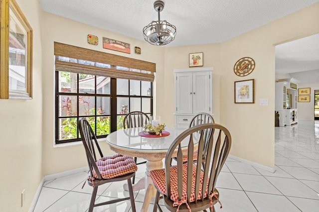 11265 Bannock Ave Unit 5, Boynton Beach, FL 33437 - dining area featuring a chandelier, light tile patterned flooring, and a textured ceiling