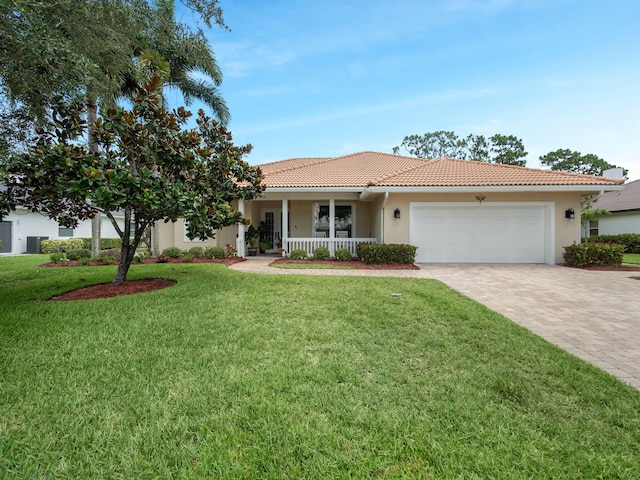 8868 SW Fishermans Wharf Dr, Stuart, FL 34997 - ranch-style house with a porch, decorative driveway, an attached garage, and stucco siding