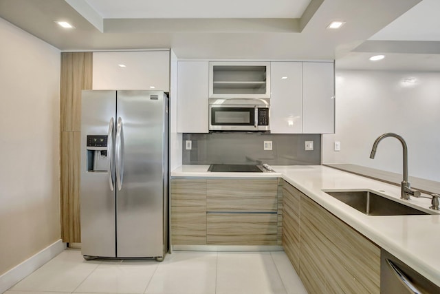 3600 NE 170th St Unit 407, North Miami Beach, FL 33160 - kitchen featuring stainless steel appliances, modern cabinets, light countertops, light tile patterned floors, and recessed lighting