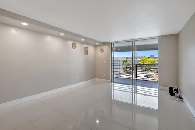 3600 NE 170th St Unit 407, North Miami Beach, FL 33160 - unfurnished room with recessed lighting, light tile patterned flooring, and floor to ceiling windows