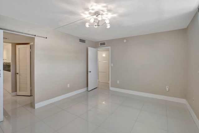 3600 NE 170th St Unit 407, North Miami Beach, FL 33160 - spare room with light tile patterned flooring and a chandelier