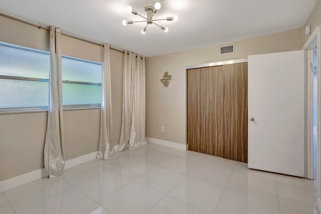 3600 NE 170th St Unit 407, North Miami Beach, FL 33160 - tiled empty room with a chandelier and a smoke detector