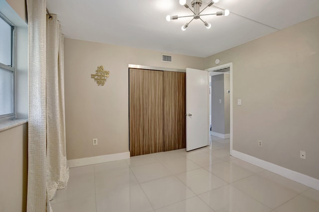 3600 NE 170th St Unit 407, North Miami Beach, FL 33160 - unfurnished bedroom featuring a chandelier and light tile patterned flooring