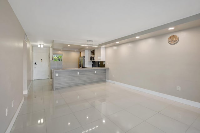 3600 NE 170th St Unit 407, North Miami Beach, FL 33160 - unfurnished living room featuring light tile patterned flooring and recessed lighting
