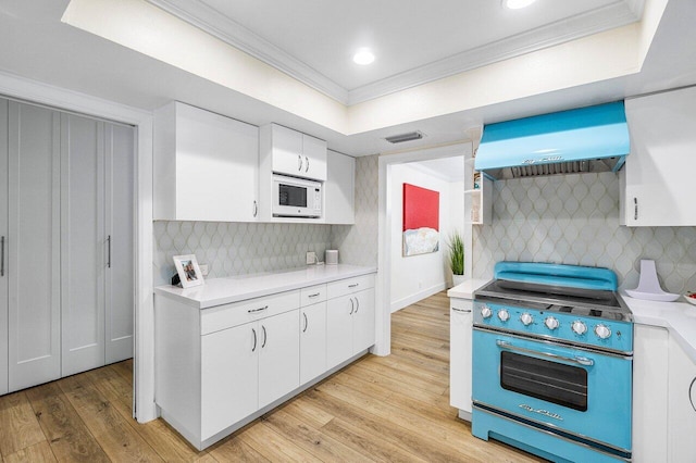 881 Elderberry Way, Boca Raton, FL 33486 - kitchen with range hood, high end stainless steel range, ornamental molding, light countertops, and white cabinets