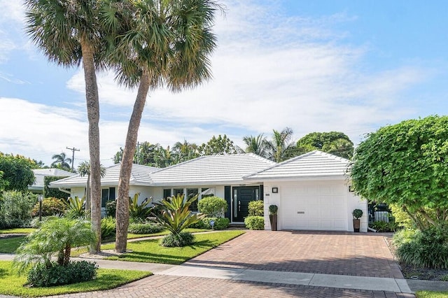 881 Elderberry Way, Boca Raton, FL 33486 - ranch-style house featuring decorative driveway, a garage, a tile roof, and stucco siding