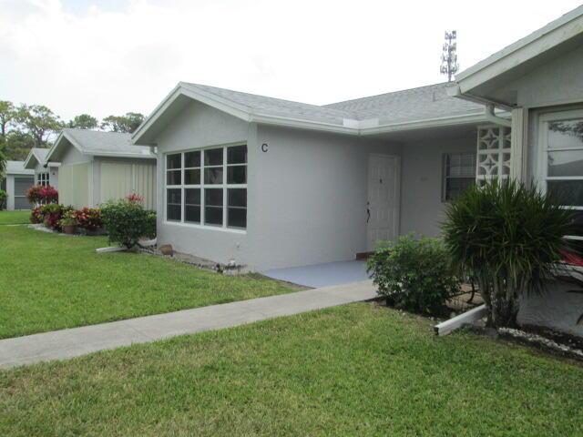 14572 Canalview Dr Unit C, Delray Beach, FL 33484 - view of front of house featuring a front lawn and stucco siding