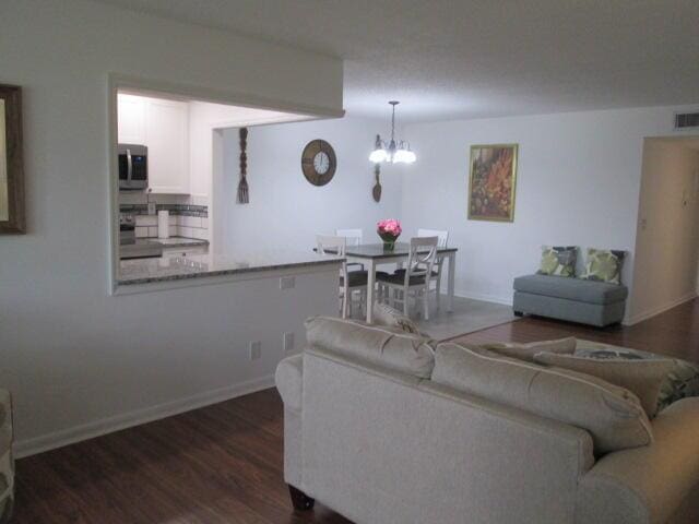 14572 Canalview Dr Unit C, Delray Beach, FL 33484 - living area featuring a chandelier and dark wood-style floors