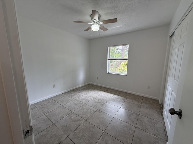 2564 Navajo Ave, Fort Pierce, FL 34946 - unfurnished room with tile patterned floors, a textured ceiling, and ceiling fan