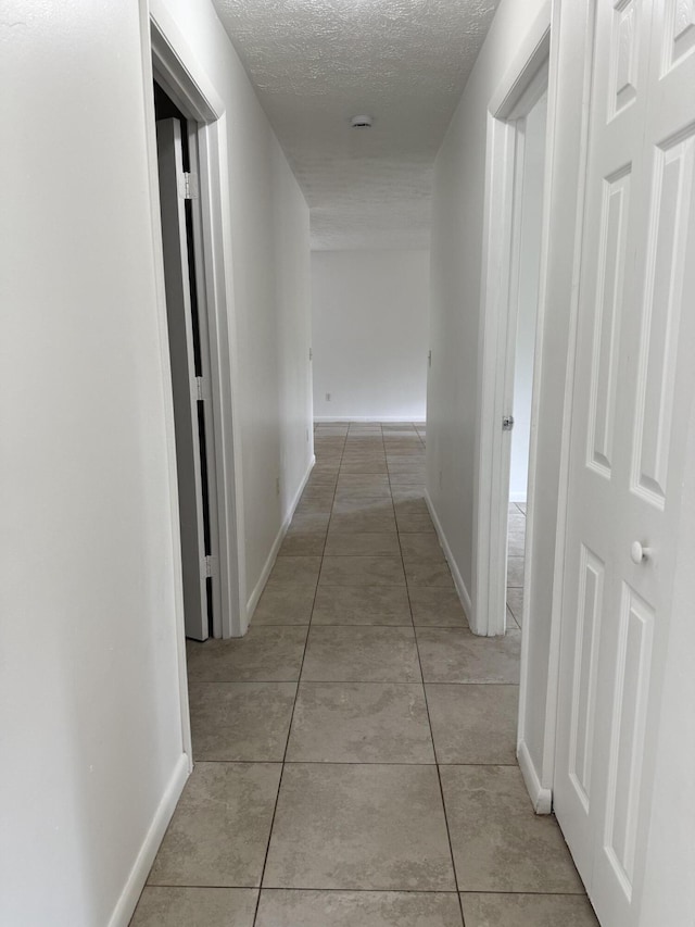 2564 Navajo Ave, Fort Pierce, FL 34946 - hall featuring light tile patterned floors and a textured ceiling