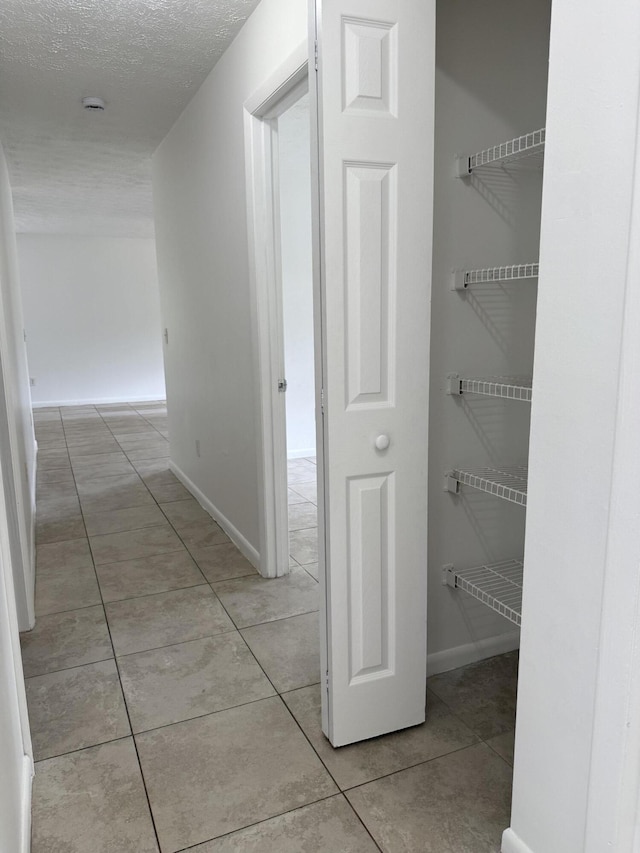 2564 Navajo Ave, Fort Pierce, FL 34946 - hallway with light tile patterned floors and a textured ceiling