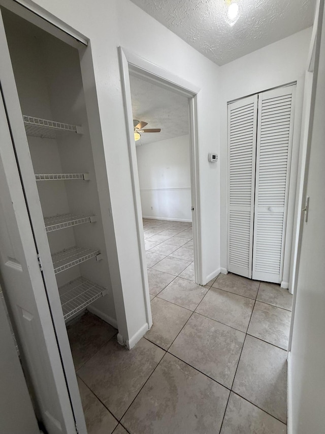 2564 Navajo Ave, Fort Pierce, FL 34946 - hallway featuring a textured ceiling and light tile patterned floors