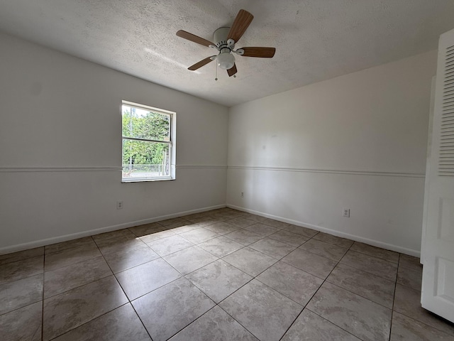 2564 Navajo Ave, Fort Pierce, FL 34946 - empty room with a textured ceiling, tile patterned floors, and a ceiling fan