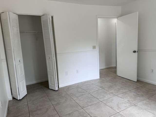 2564 Navajo Ave, Fort Pierce, FL 34946 - unfurnished bedroom with light tile patterned floors and a closet