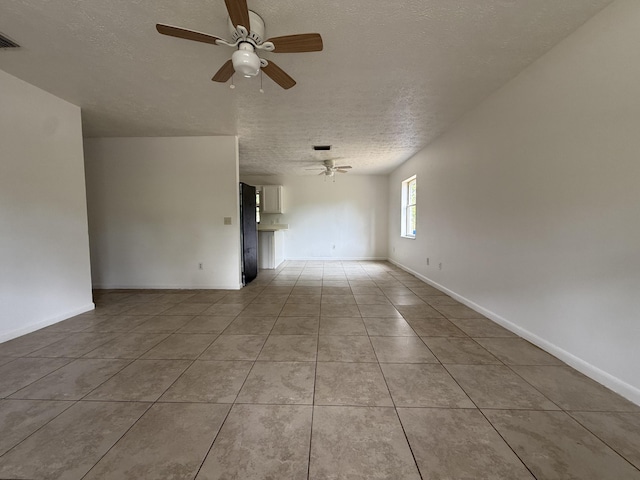 2564 Navajo Ave, Fort Pierce, FL 34946 - spare room featuring a textured ceiling, ceiling fan, and light tile patterned flooring
