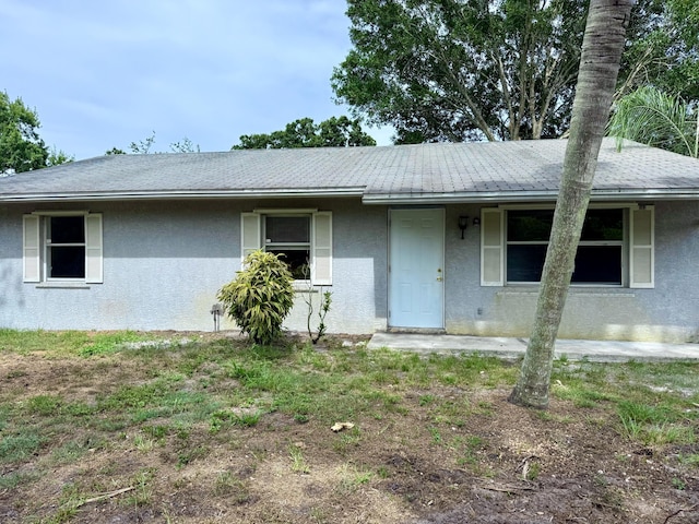 2564 Navajo Ave, Fort Pierce, FL 34946 - ranch-style house featuring stucco siding and roof with shingles