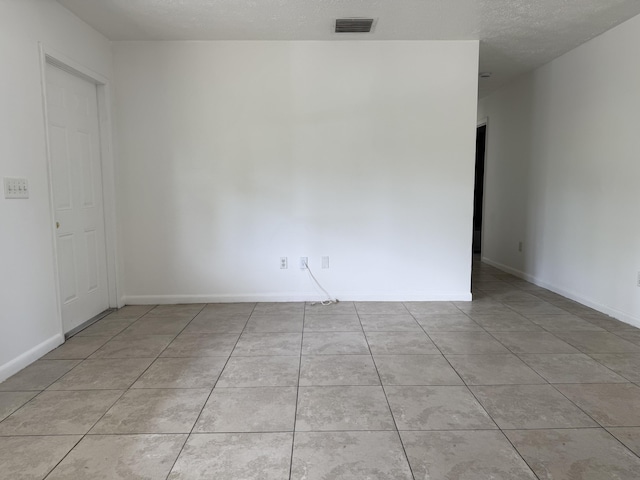 2564 Navajo Ave, Fort Pierce, FL 34946 - tiled spare room featuring baseboards